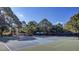 Community tennis courts featuring shade umbrellas and lush surrounding trees for a pleasant playing experience at 1540 Strathmore Ln, Mount Pleasant, SC 29464