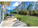 Relaxing backyard patio area with seating, a blue umbrella, and beautifully landscaped surroundings for outdoor enjoyment at 157 Sea Lavender Ln, Summerville, SC 29486