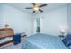 Comfortable bedroom with ceiling fan, writing desk, blue bedding, and ample natural light at 157 Sea Lavender Ln, Summerville, SC 29486