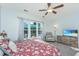Cozy bedroom with ceiling fan, plush carpet, and large windows at 157 Sea Lavender Ln, Summerville, SC 29486