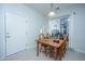 Dining room with a wooden table set for four, a window providing natural light, and a door at 157 Sea Lavender Ln, Summerville, SC 29486