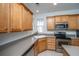 Well-lit kitchen featuring stainless steel appliances, wooden cabinets, and a window over the sink at 157 Sea Lavender Ln, Summerville, SC 29486