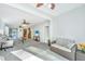 Open living room boasts abundant light, neutral carpet and sightlines to the kitchen at 157 Sea Lavender Ln, Summerville, SC 29486