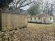 Backyard of a home with a shed in a leaf-covered yard with the house in the background at 1610 Larry St, North Charleston, SC 29406