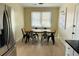 Cozy dining area with a wooden table, seating for six, and natural light at 1610 Larry St, North Charleston, SC 29406