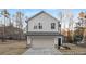 Charming two-story home with a two-car garage and neutral siding, nestled on a spacious lot with mature trees at 169 Surf Bird St # 514P, Summerville, SC 29486