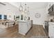 Open concept kitchen featuring stainless appliances, white cabinets, an island with bar seating that flows into the living room at 169 Surf Bird St # 514P, Summerville, SC 29486