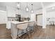 Bright, modern kitchen with white cabinets, stainless steel appliances, pendant lighting, and a center island with barstool seating at 169 Surf Bird St # 514P, Summerville, SC 29486