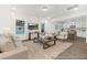 Bright and spacious living room open to the kitchen, with large windows, and modern decor for a comfortable living space at 169 Surf Bird St # 514P, Summerville, SC 29486