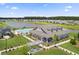 Aerial view of a community clubhouse with a pool, pond, and green space at 169 Surf Bird St # 514P, Summerville, SC 29486