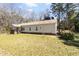 A single-story home showing its side and rear with a well-maintained lawn at 1816 Grimball Rd, Charleston, SC 29412