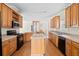 Well-lit kitchen featuring an island, wood cabinetry, updated appliances, and an open dining area at 1816 Grimball Rd, Charleston, SC 29412