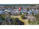 Aerial view of a neighborhood highlighting one property, pond, walking trails and a playground at 1818 Towne St, Johns Island, SC 29455