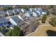 An aerial view shows homes and a community pond with walking trails and a playground area at 1818 Towne St, Johns Island, SC 29455