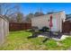 Fenced backyard with lawn, barbecue grill and outdoor patio set with umbrella on a sunny day at 1818 Towne St, Johns Island, SC 29455