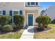 Inviting front entrance with a blue door and manicured landscaping at 1818 Towne St, Johns Island, SC 29455