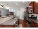 Well-equipped kitchen featuring granite counters, stainless appliances, and dark wood cabinetry at 1818 Towne St, Johns Island, SC 29455