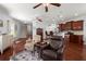Open-concept living room with hardwood floors, ceiling fans, and seamless flow into a modern kitchen at 1818 Towne St, Johns Island, SC 29455