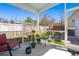 Screened patio with furniture and view of fenced yard at 1818 Towne St, Johns Island, SC 29455