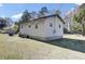 The backyard shows the house's light siding and concrete foundation at 1879 Richmond St, Charleston, SC 29407