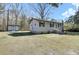 Quaint single-story home with black shutters and a utility shed in the backyard at 1879 Richmond St, Charleston, SC 29407