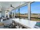 Outdoor dining on the covered patio with marsh view and an inviting fireplace at 1899 N James Gregarie Rd, Mount Pleasant, SC 29466