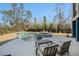 Backyard in-ground pool and stone hot tub are surrounded by lush landscaping and outdoor lounge area at 1899 N James Gregarie Rd, Mount Pleasant, SC 29466