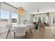Sunlit dining area open to the living area, featuring modern light fixtures and large windows at 1039 Swamp Rose Run, Summerville, SC 29485