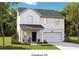 Charming two-story home featuring a well-manicured lawn and an attached two-car garage at 1039 Swamp Rose Run, Summerville, SC 29485