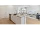 Modern kitchen island with stainless steel sink, granite countertops, and open layout to the living area at 1932 Nola Run, Summerville, SC 29485