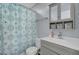 Well-lit bathroom with stylish vanity, medicine cabinet, and shower with patterned curtain at 200 Short Woods Ct, Summerville, SC 29486