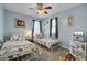 Nautical-themed bedroom with two twin beds, light blue walls, and a ceiling fan for added comfort at 200 Short Woods Ct, Summerville, SC 29486