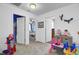 Carpeted bedroom with three doorways and several toys and decor items at 200 Short Woods Ct, Summerville, SC 29486