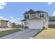 Charming two-story home with a two car garage, neutral siding and decorative stone accents at 200 Short Woods Ct, Summerville, SC 29486