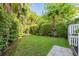 Lush backyard with a well-maintained lawn, vibrant greenery, and various trees, creating a private outdoor retreat at 21 Limehouse St, Charleston, SC 29401