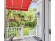 View of the private backyard from the outdoor porch with stairs leading to a lush garden and landscaping at 21 Limehouse St, Charleston, SC 29401
