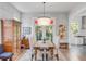 Bright dining room featuring a wooden table, elegant chairs, and eye-catching chandelier near outdoor view at 21 Limehouse St, Charleston, SC 29401