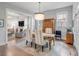 Stylish dining room with a wooden table, seating for six, wooden floors, and a view to the living room at 21 Limehouse St, Charleston, SC 29401