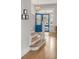 Bright foyer with a modern blue door, hardwood floors, stairs, and a stylish light fixture at 21 Limehouse St, Charleston, SC 29401