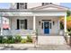 Inviting front porch with white columns, a bright blue front door, and manicured landscaping at 21 Limehouse St, Charleston, SC 29401