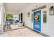 Comfortable front porch seating area featuring a bright blue front door with decorative wreath at 21 Limehouse St, Charleston, SC 29401
