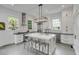 Modern kitchen with stainless steel appliances, a large island, and custom white cabinetry at 21 Limehouse St, Charleston, SC 29401