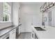 Sleek kitchen design with stainless steel appliances, quartz countertops, and custom white cabinetry at 21 Limehouse St, Charleston, SC 29401