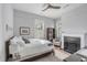 Comfortable main bedroom with a fireplace, neutral color palette, and bright windows, creating a cozy and relaxing space at 21 Limehouse St, Charleston, SC 29401