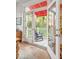 Inviting outdoor porch featuring a wooden rocking chair with a beautiful backyard and tropical trees at 21 Limehouse St, Charleston, SC 29401