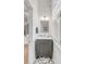 Cozy powder room featuring a gray vanity with a marble countertop and decorative patterned flooring at 21 Limehouse St, Charleston, SC 29401