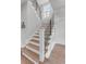 Elegant staircase with wood treads, white risers, a black metal railing, and natural light from window at 21 Limehouse St, Charleston, SC 29401