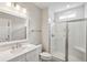 Bright bathroom featuring white countertops, framed mirror, tile flooring and glass enclosed shower at 210 Quimby Hill Dr, Huger, SC 29450