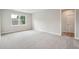 Bedroom features neutral carpet, neutral walls, white trim, and a window at 210 Quimby Hill Dr, Huger, SC 29450