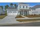 Charming two-story home featuring a two-car garage, covered porch, and manicured front yard at 210 Quimby Hill Dr, Huger, SC 29450
